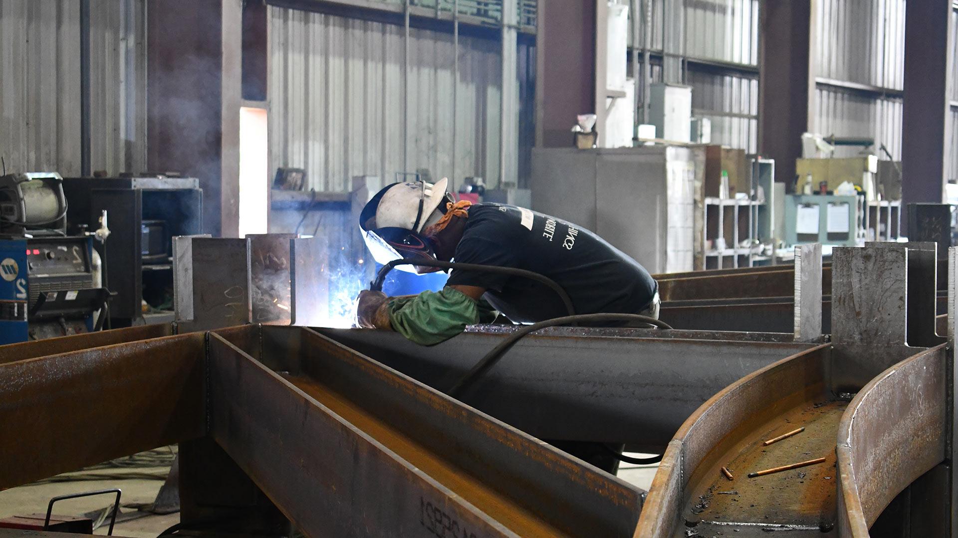 Man welding in a steel shop.